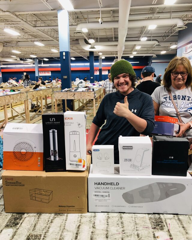 A customer holding up brand-name finds at Krazy Binz