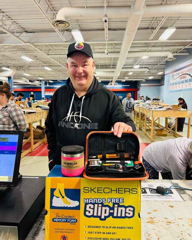 A Krazy Binz customer holding his weekly haul of brand-name finds